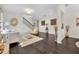 Open-concept living room with hardwood floors, staircase, and access to a dining area at 7895 Pleasant Pine Cir, Winter Park, FL 32792