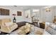 Bright living room featuring hardwood floors, neutral colors, and access to the dining area at 7895 Pleasant Pine Cir, Winter Park, FL 32792