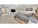 Spacious main bedroom featuring neutral colors, carpet floors, and an entertainment area at 7895 Pleasant Pine Cir, Winter Park, FL 32792