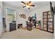 Bright office space with a large window, desk, and built-in shelving at 7895 Pleasant Pine Cir, Winter Park, FL 32792