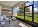 Relaxing screened patio featuring comfortable wicker furniture and views of the landscaped backyard at 7895 Pleasant Pine Cir, Winter Park, FL 32792