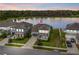 Aerial view of home with lake view and solar panels, complemented by lush greenery at 840 Livestock Loop, St Cloud, FL 34771