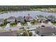 Aerial view of a charming home near a serene lake, highlighting the neighborhood's peaceful setting at 840 Livestock Loop, St Cloud, FL 34771