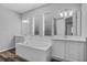 Luxurious bathroom with a soaking tub, double sinks, and plenty of counter space with natural lighting at 840 Livestock Loop, St Cloud, FL 34771