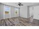 Spacious bedroom featuring wood-look floors, large windows, and a clean, minimalist aesthetic at 840 Livestock Loop, St Cloud, FL 34771
