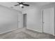 Spacious bedroom featuring carpet, a ceiling fan, two doors, and neutral walls at 840 Livestock Loop, St Cloud, FL 34771