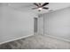 An empty gray bedroom with gray carpeting and a ceiling fan at 840 Livestock Loop, St Cloud, FL 34771