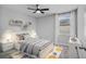 Cozy bedroom featuring a bed, carpet, a ceiling fan, and a window with views at 840 Livestock Loop, St Cloud, FL 34771