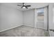 Minimal bedroom featuring carpet, a ceiling fan, and a window with views at 840 Livestock Loop, St Cloud, FL 34771