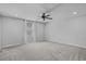 Bright and airy bedroom featuring neutral walls, carpet, ceiling fan and a window at 840 Livestock Loop, St Cloud, FL 34771