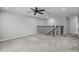Spacious bonus room featuring plush carpeting and a decorative staircase with black iron spindles at 840 Livestock Loop, St Cloud, FL 34771
