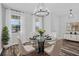 Dining room with a glass-top table, seating for four, chandelier, and lots of natural light at 840 Livestock Loop, St Cloud, FL 34771