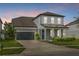 Charming two-story home with well-manicured lawn and inviting front porch with large garage at 840 Livestock Loop, St Cloud, FL 34771