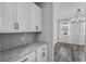 Close-up of the kitchen area, showcasing white cabinets, granite countertops, and stylish backsplash at 840 Livestock Loop, St Cloud, FL 34771