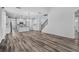 Spacious living area featuring elegant wood floors, connecting the kitchen and dining spaces at 840 Livestock Loop, St Cloud, FL 34771