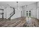 Bright living room with soaring ceilings, stylish chandelier, and patio doors leading to backyard at 840 Livestock Loop, St Cloud, FL 34771