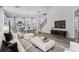 Open-concept living room featuring a modern design, staircase and seamlessly connected kitchen at 840 Livestock Loop, St Cloud, FL 34771