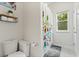 Bathroom featuring a colorful shower curtain, toilet, and storage at 9814 Amber Chestnut Way, Winter Garden, FL 34787