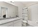 Well-lit bathroom featuring a granite countertop, a mirror, and a shower-tub combination at 9814 Amber Chestnut Way, Winter Garden, FL 34787
