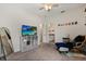 Bright bedroom featuring a TV, adjacent bathroom, and comfortable seating at 9814 Amber Chestnut Way, Winter Garden, FL 34787