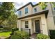 A welcoming two-story home featuring manicured landscaping and a dark-colored front door with a wreath at 9814 Amber Chestnut Way, Winter Garden, FL 34787