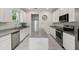 Modern kitchen featuring granite countertops, stainless steel appliances, and white cabinets at 9814 Amber Chestnut Way, Winter Garden, FL 34787