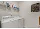 Functional laundry room with modern washer and dryer units and ample storage space at 9814 Amber Chestnut Way, Winter Garden, FL 34787