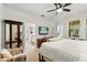 Bright main bedroom featuring a ceiling fan, TV, and ensuite bathroom at 9814 Amber Chestnut Way, Winter Garden, FL 34787