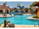 A vibrant splash pad area with a slide and various water features amidst tropical landscaping and lounge seating at 9814 Amber Chestnut Way, Winter Garden, FL 34787