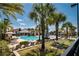 Resort-style pool area with lounge chairs, palm trees, and a clubhouse, creating an inviting outdoor oasis at 9814 Amber Chestnut Way, Winter Garden, FL 34787