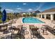 Resort-style community pool with comfortable lounge chairs and shaded umbrellas at 9814 Amber Chestnut Way, Winter Garden, FL 34787