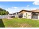 View of the backyard with patio, grill, white fencing and grass area at 999 Mancha Real Dr, Orlando, FL 32807