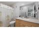 Bathroom featuring a shower with palm tree curtains, vanity with sink and a large mirror at 999 Mancha Real Dr, Orlando, FL 32807
