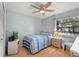Cozy bedroom featuring a ceiling fan, a full-sized bed, and a bright window at 999 Mancha Real Dr, Orlando, FL 32807