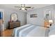 Bedroom featuring tile floors, a ceiling fan, and dresser with a large decorative mirror at 999 Mancha Real Dr, Orlando, FL 32807