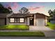 Charming single-story home with well-manicured lawn, neutral paint scheme, and attached one car garage at 999 Mancha Real Dr, Orlando, FL 32807