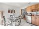 Eat-in kitchen with stainless steel dishwasher, a round glass top dining table, and a breakfast bar at 999 Mancha Real Dr, Orlando, FL 32807