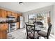 Bright eat-in kitchen with updated stainless steel appliances and a glass top dining table at 999 Mancha Real Dr, Orlando, FL 32807