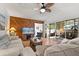 Inviting living room with wood floors, sliding glass doors to patio, and a wood accent wall at 999 Mancha Real Dr, Orlando, FL 32807