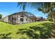 Expansive backyard with a well-manicured lawn and a screened-in pool, perfect for outdoor enjoyment and privacy at 1019 Lake Berkley Dr, Kissimmee, FL 34746