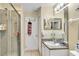 Bathroom with a glass shower, a vanity with countertop, and views into the hall and dining room at 1019 Lake Berkley Dr, Kissimmee, FL 34746