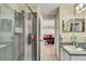 Bathroom with a glass-enclosed shower, tile surround, and a view into the dining room at 1019 Lake Berkley Dr, Kissimmee, FL 34746