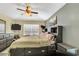 Comfortable bedroom with a ceiling fan, large window, TV, and well-coordinated gray furniture at 1019 Lake Berkley Dr, Kissimmee, FL 34746