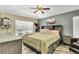 Inviting bedroom with a full bed, complemented by a dresser and a well-lit window for natural light at 1019 Lake Berkley Dr, Kissimmee, FL 34746