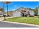 Charming single-Gathering home with a well-manicured lawn, mature landscaping, and a two-car garage at 1019 Lake Berkley Dr, Kissimmee, FL 34746