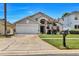 Inviting single-Gathering home featuring a lush lawn, a two-car garage and decorative plants at 1019 Lake Berkley Dr, Kissimmee, FL 34746