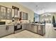 Modern kitchen with gray cabinets, stainless steel appliances, and an open view to the living area at 1019 Lake Berkley Dr, Kissimmee, FL 34746