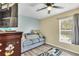Comfortable living room with a cozy sofa, ceiling fan, TV, and a bright window view at 1019 Lake Berkley Dr, Kissimmee, FL 34746