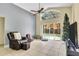 Bright living room with tile flooring, a ceiling fan, and sliding doors leading to a pool area at 1019 Lake Berkley Dr, Kissimmee, FL 34746
