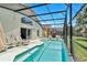 Screened-in pool area features a bright pool, comfortable lounge chairs and outdoor seating on a sunny day at 1019 Lake Berkley Dr, Kissimmee, FL 34746